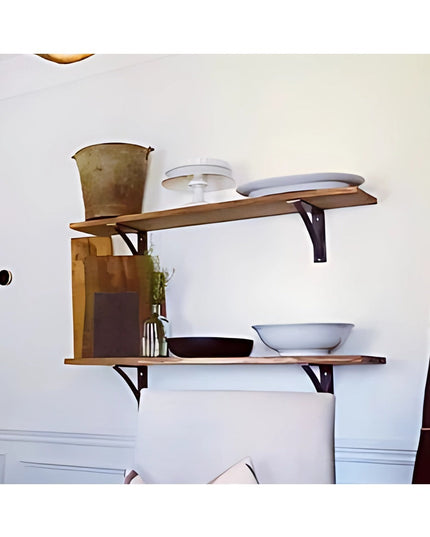Black steel Pops 2" industrial shelf brackets supporting wooden shelves with dishes and home decor items on white wall - I...
