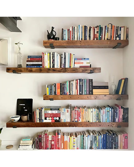 Black metal Jane J Style Shelf Brackets by Industrial Farm Co supporting rustic wood floating shelves filled with colorful...