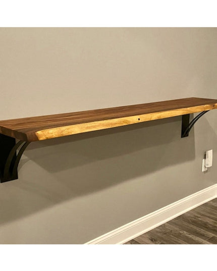 The Little Falls Metal Corbel by Industrial Farm Co supporting a wood shelf, featuring black metal bracket with curved des...