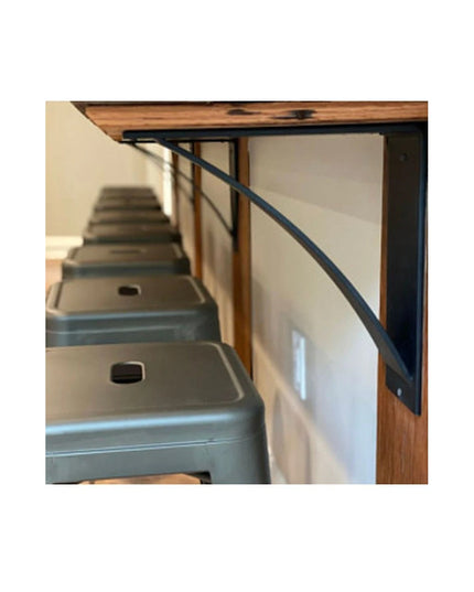 Heavy duty black steel Albany 4-inch curved shelf brackets supporting wooden stairs in modern industrial home interior by ...