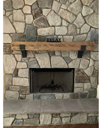 Rustic wooden mantel with black steel Clermont 4" brackets mounted on natural stone fireplace, Industrial Farm Co heavy du...