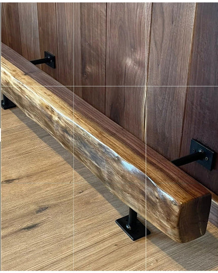 Black metal bar foot rail brackets supporting rustic wood handrail on wooden deck with glass panels - Industrial Farm Co h...