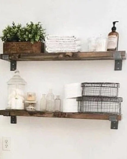 Rustic wooden floating shelves with black metal Auburn Z brackets displaying storage baskets, glass jars, and plants on wh...