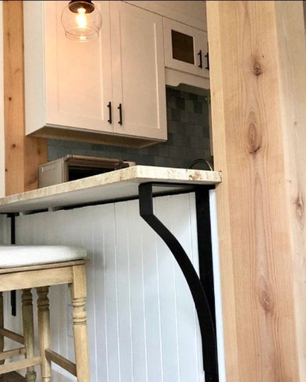 Black metal Syracuse countertop support brackets from Industrial Farm Co holding white marble counter in rustic farmhouse ...