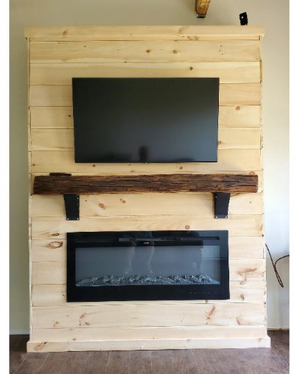 Black metal Tipp Hill Mantel Support brackets holding rustic wood beam on light pine shiplap fireplace wall with mounted T...