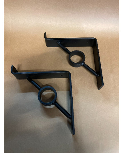 Two black metal Simon Decorative Support Brackets by Industrial Farm Co with triangular design and circular center detail ...