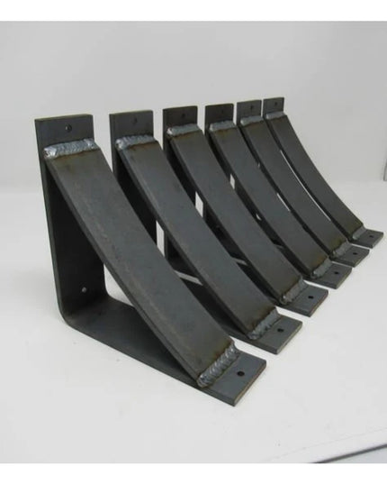 Six black metal Hattie Style curved shelf bracket supports with welded joints arranged in a row, showing Industrial Farm C...