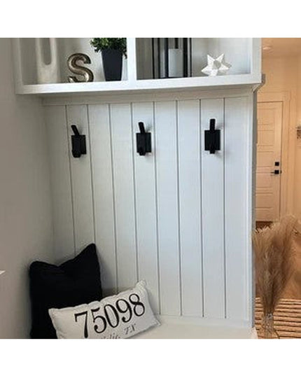 Black metal Elizabeth Wall Hooks by Industrial Farm Co mounted on white beadboard wainscoting in modern farmhouse entryway