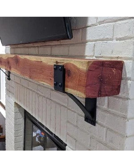 Spafford 3 inch black steel mantel bracket with rivets supporting reclaimed wood beam on white brick fireplace by Industri...