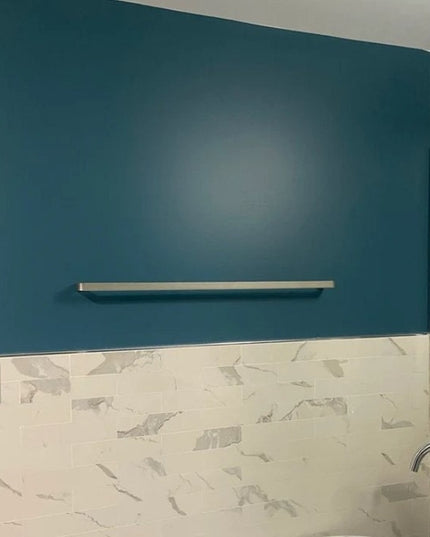 Sleek white Emma Towel Holder by Industrial Farm Co mounted on teal bathroom wall above marble countertop and sink