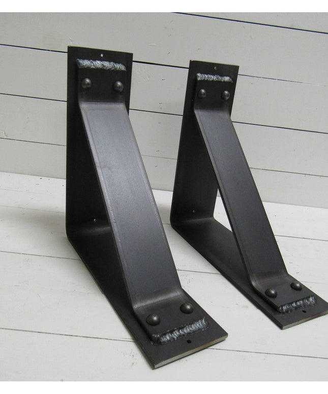 Two black metal Ithaca Rustic Bracket Supports by Industrial Farm Co with welded steel construction and mounting holes on ...