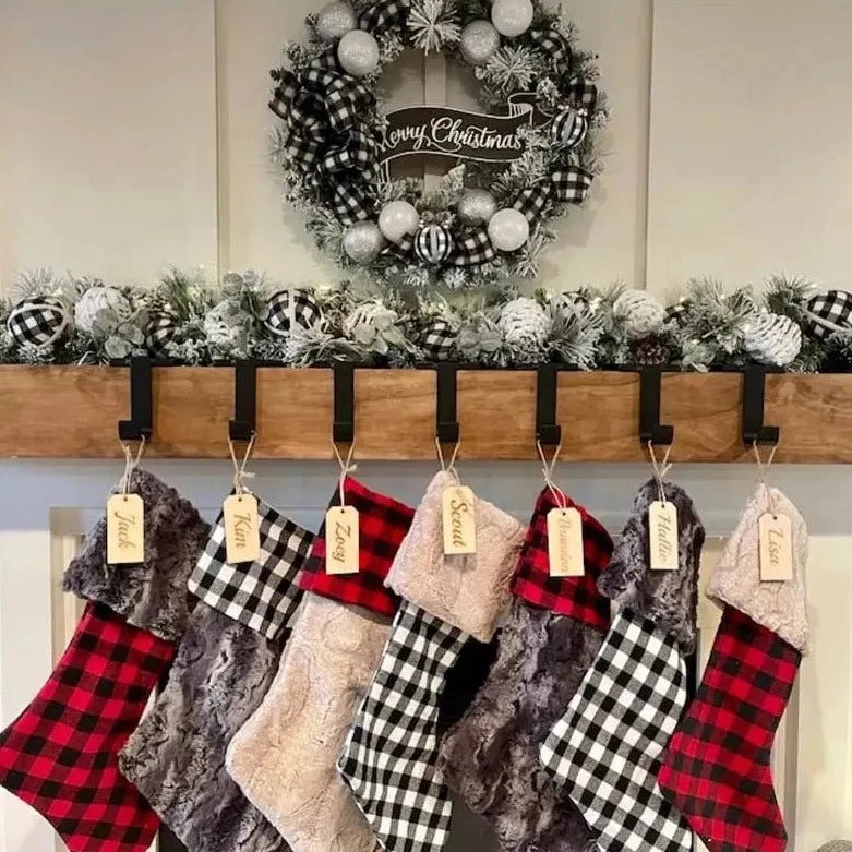 Steel Christmas stocking holder with a sleek, metallic finish. The holder features a sturdy base to securely grip the edge of a mantel or shelf. The top part has a decorative design, often shaped like a festive figure such as a snowman, reindeer, or star, providing a stylish and functional way to hang holiday stockings.